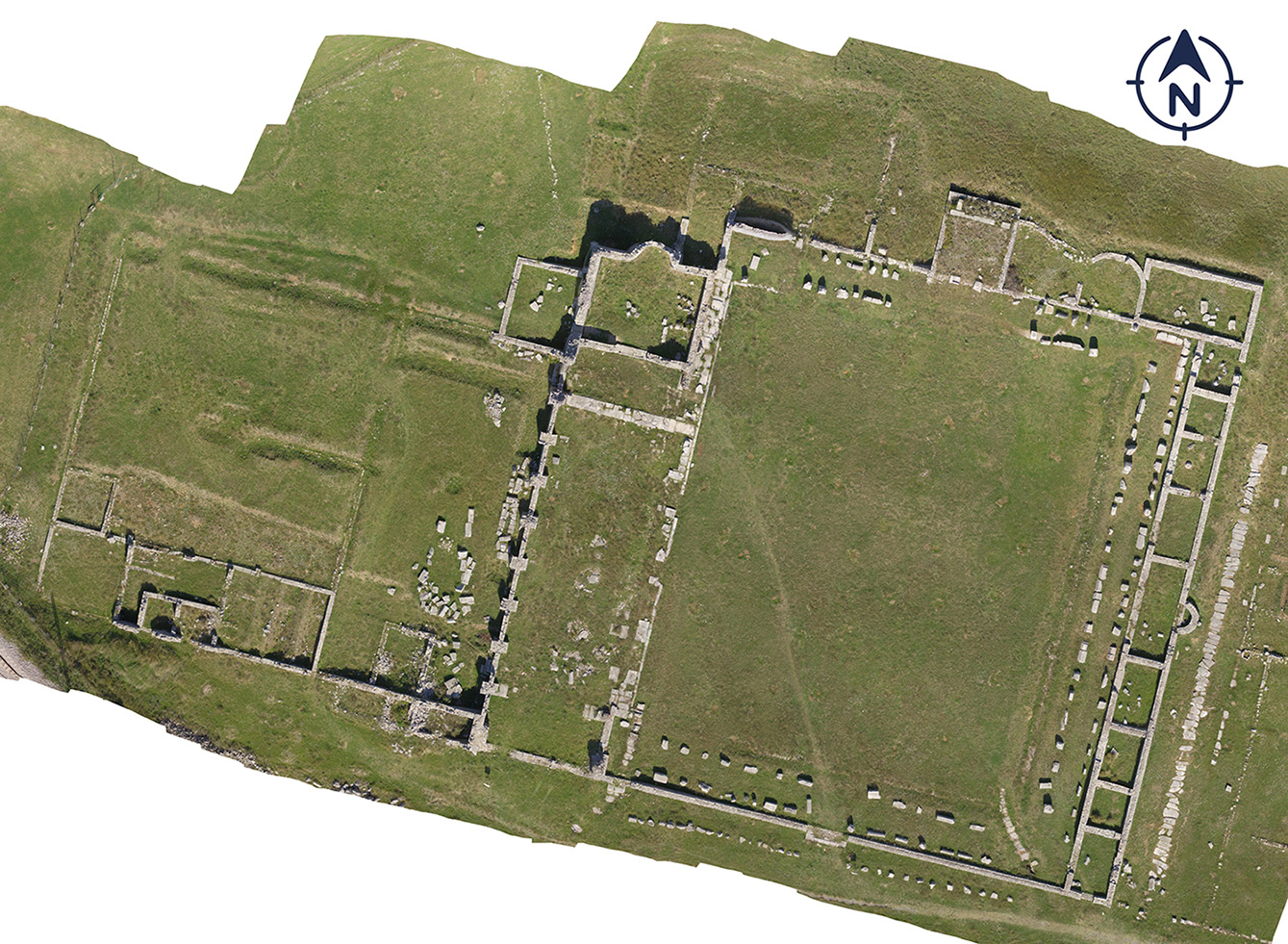 Aerial view of the forum of Doclea, captured by drone. The outlines of the main structures in this central space, essential to the city's public and political life, are clearly distinguishable.